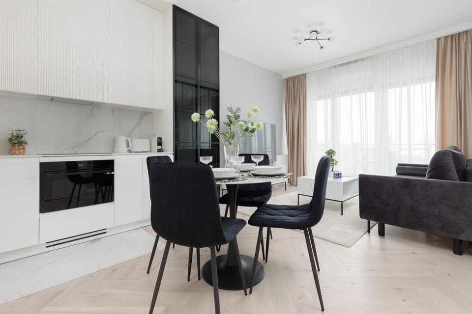 Open dining and kitchen area with a clean white aesthetic and a functional design.

