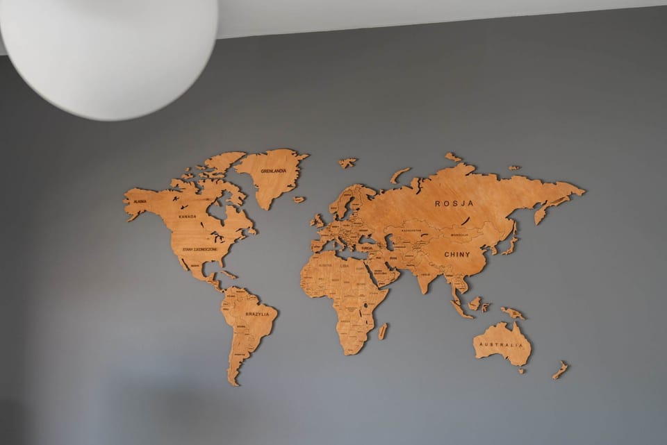 Close-up of a decorative wall with a wooden world map, adding a stylish touch to the interior.


