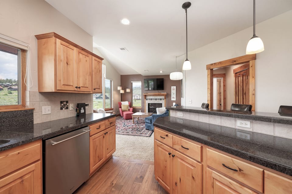 Your gourmet kitchen flows seamlessly into the living area, creating the perfect space for cooking and entertaining with mountain views.
