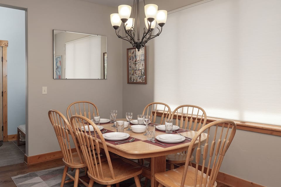 Gather around your elegant dining table where warm wood tones and gentle lighting create the perfect setting for memorable meals together.