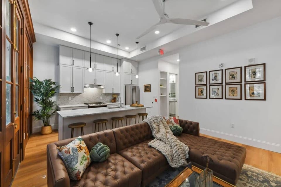 Welcome! Living Room | Spacious Lounge Area with Seating and TV for Group Relaxation | First Floor