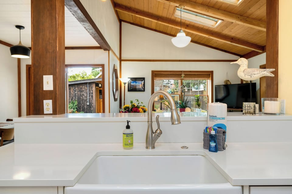 Fully equipped kitchen with side yard access to Gas BBQ. Open to the living area.