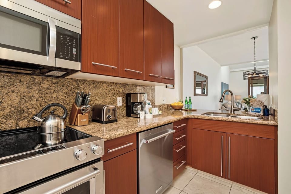 Gourmet-ready kitchen with rich cabinetry and gas range.