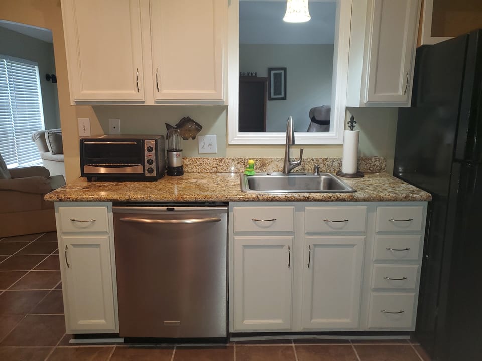 Kitchen with Sink, Dishwasher, Toaster Oven, and Bullet.