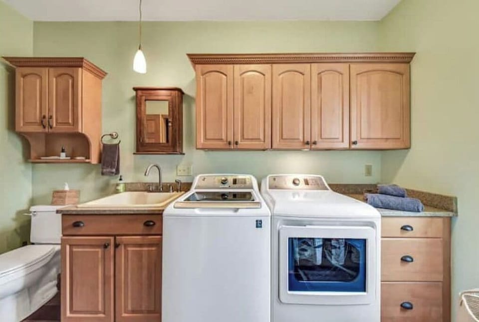 Second bathroom with shower and washer and dryer.