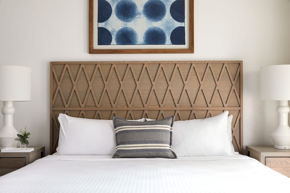 Drift off beneath a statement headboard and cloud-soft pillows.