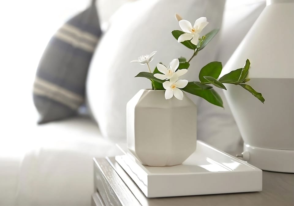 Savor peaceful morning light with fresh blooms by the bed.