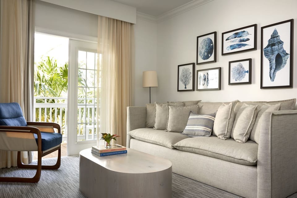Unwind on a plush sofa beside breezy balcony doors.
