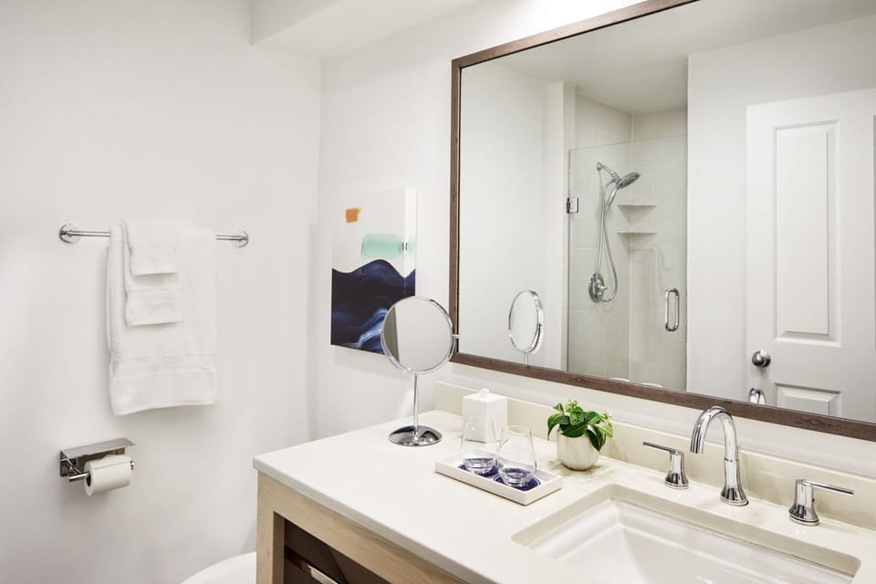 Refresh at a bright vanity with plush towels and essentials.