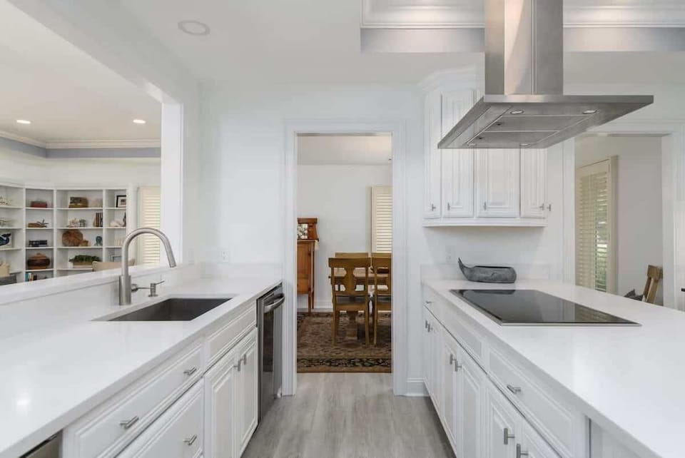  A bright, modern space with white cabinetry and sleek countertops.