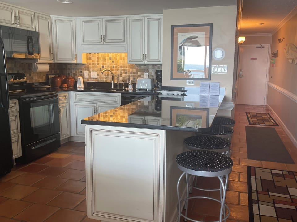 Fully stocked kitchen with Mr. Coffee, can opener & blender +island seating!