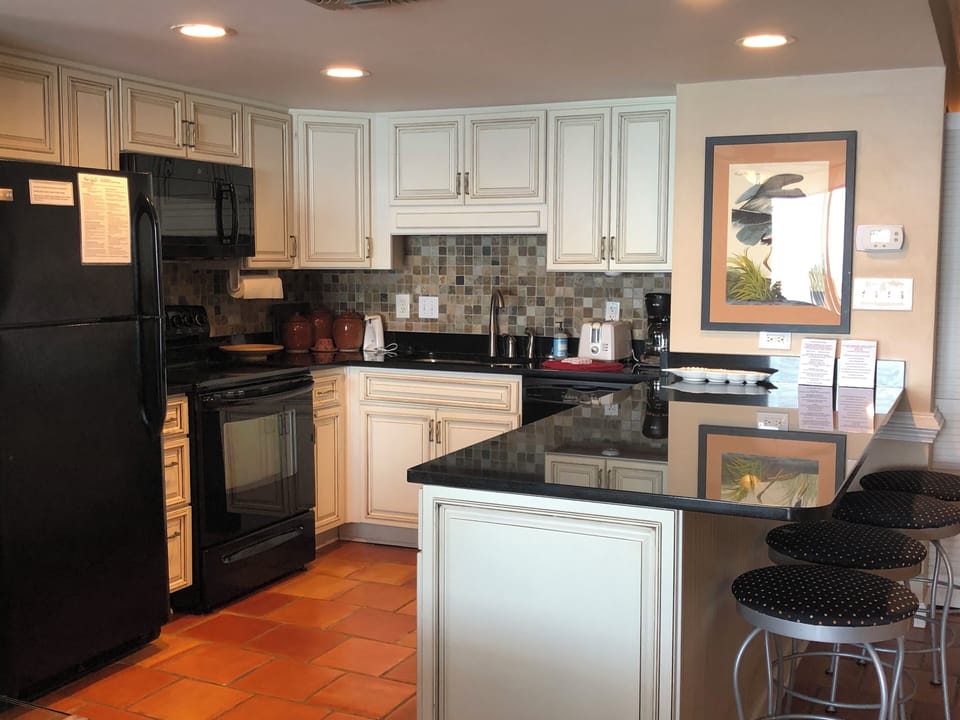 Kitchen features full-sized appliances & all the dishes, flatware & drinkware