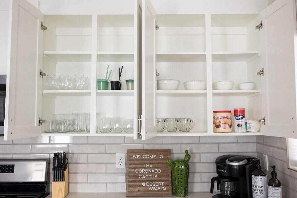 fully stocked kitchen with kids utensils and dishes as well 