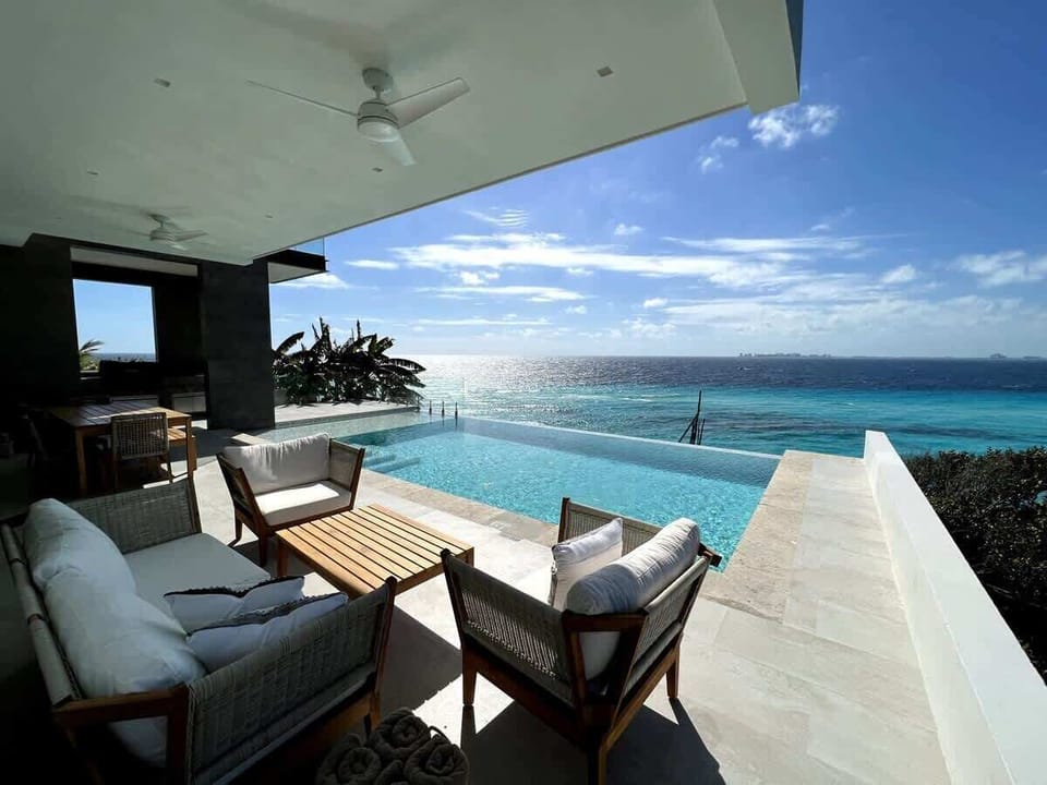 Unwind in the private pool overlooking the turquoise waters of Isla Mujeres