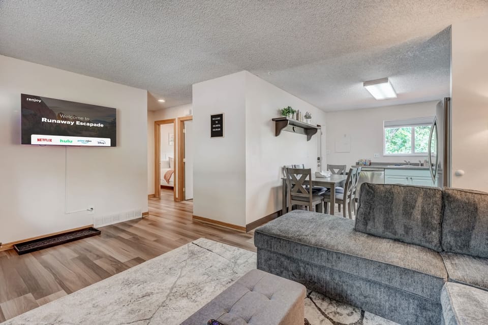 A cozy and inviting living space with plush seating, stylish decor, and an open floor plan that seamlessly connects to the kitchen—perfect for relaxing and gathering with loved ones.


