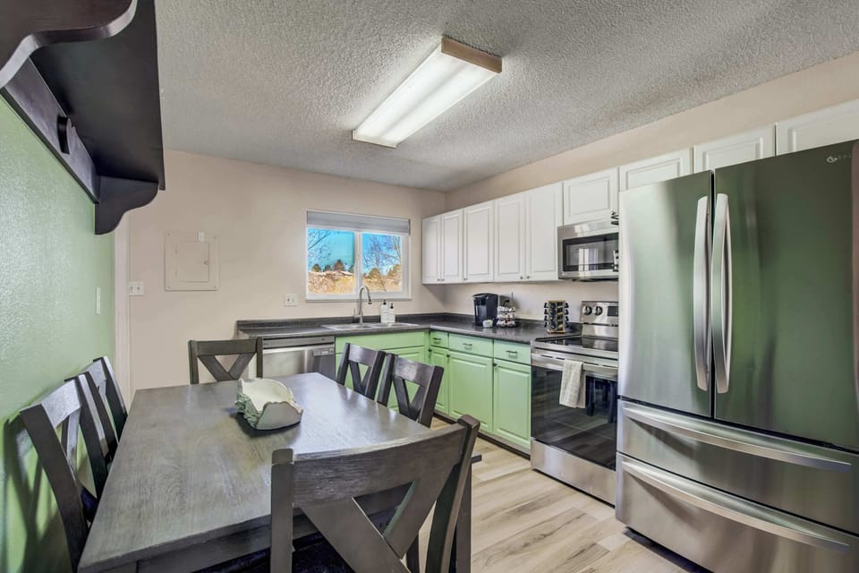 A fully stocked kitchen with modern appliances, ample counter space, and a spacious dining area—perfect for home-cooked meals and gathering with family and friends.


