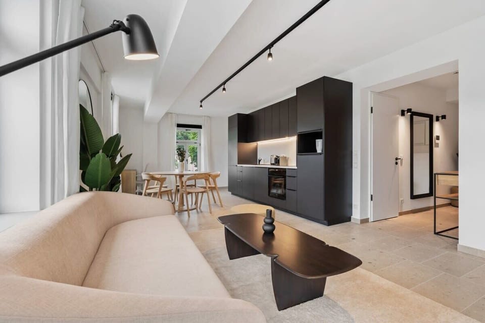 Seamless living: From the plush sofa to the sleek kitchen, every detail curates a space that's both stylish and functional. Direct bookings: www.arcaproperties.lu