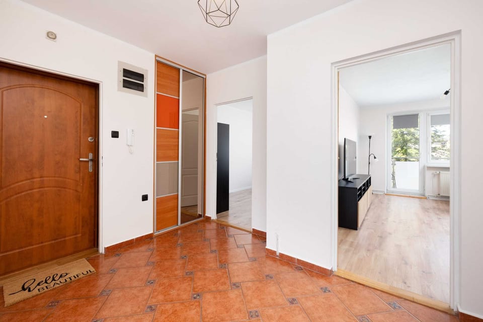 Entryway with terracotta tiles, natural lighting, and a welcoming design.

