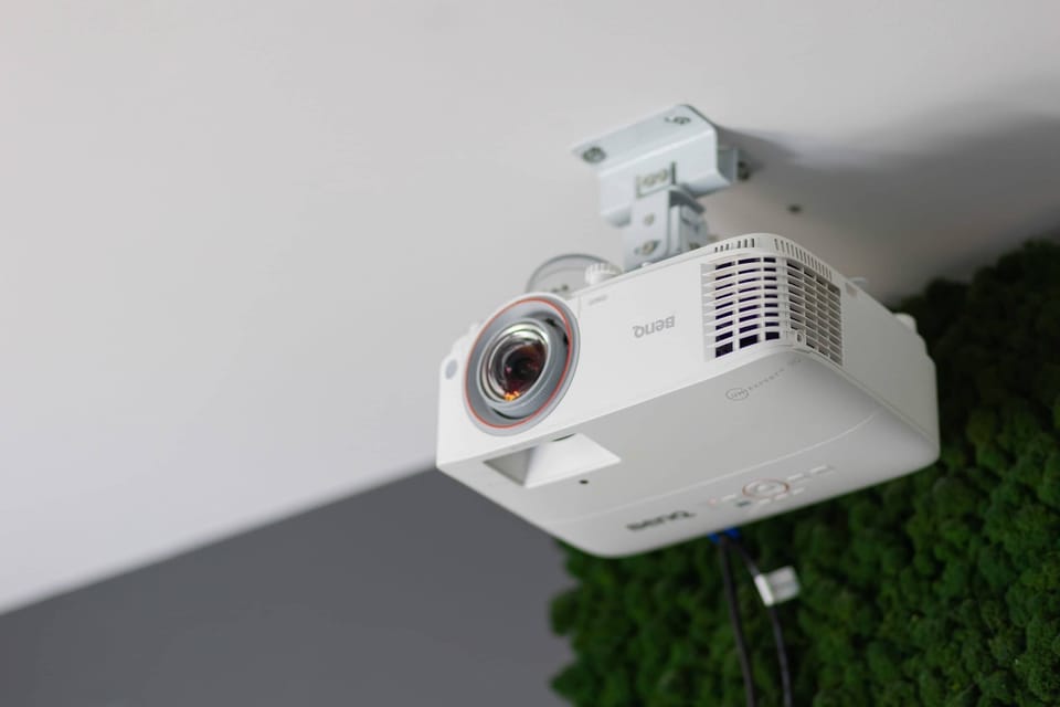 Home projector installed on the ceiling, offering an ideal setup for movie nights.

