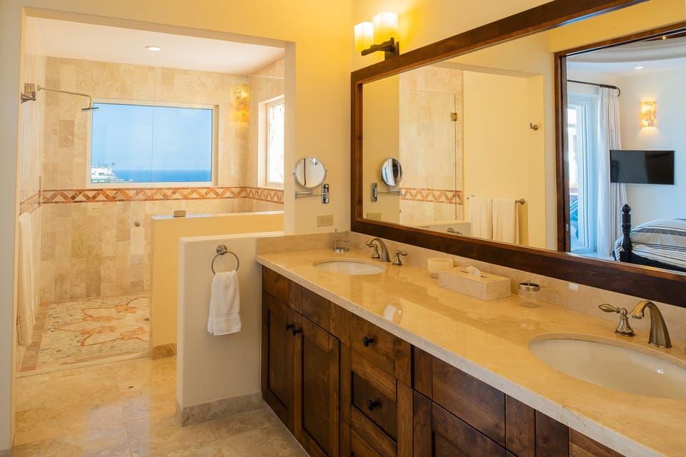En suite bathroom with walk in shower and ocean views