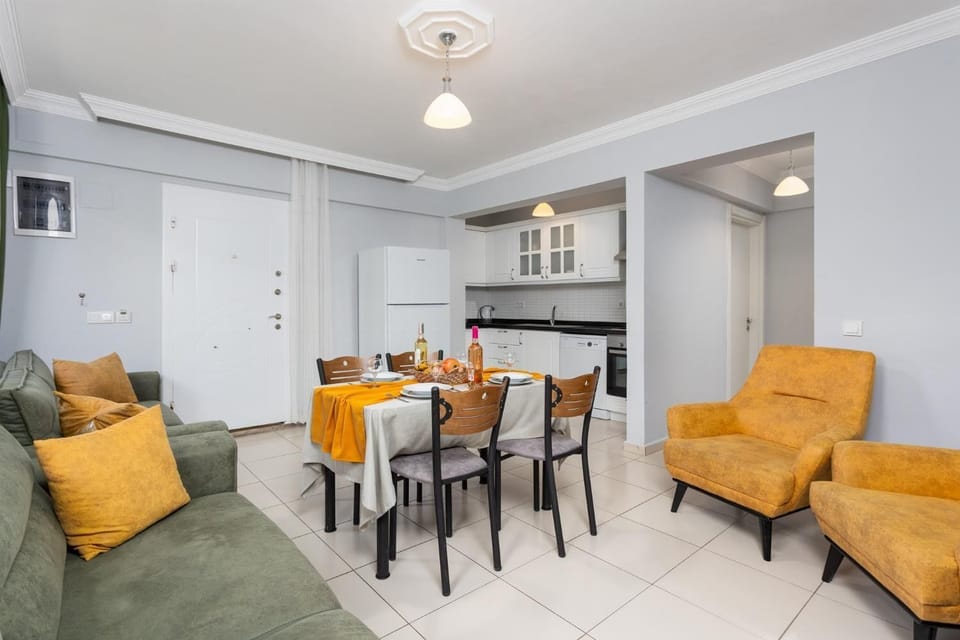 Living room with sofa, dining area, kitchen, A/C, WiFi internet, and satellite TV