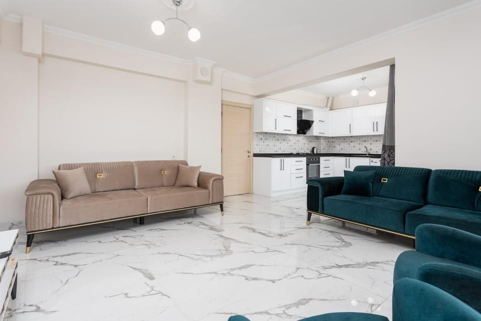 Open-plan living room with sofas, kitchen, A/C, WiFi internet and satellite TV