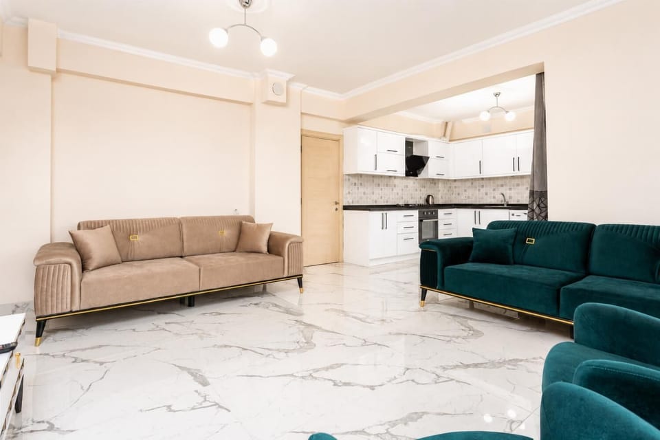 Open-plan living room with sofas, kitchen, A/C, WiFi internet and satellite TV
