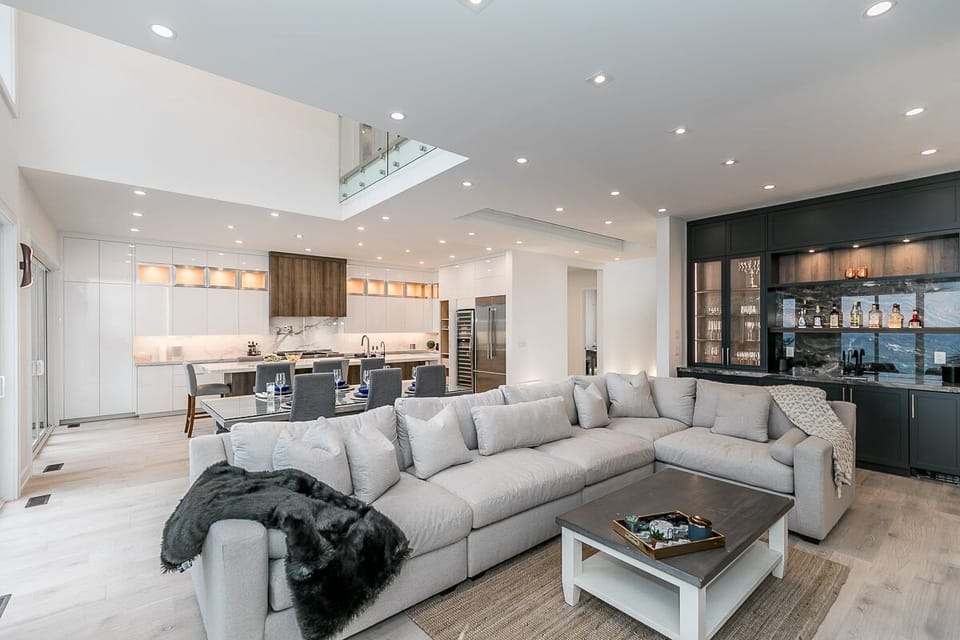 The living room's connection to the dining table and kitchen.