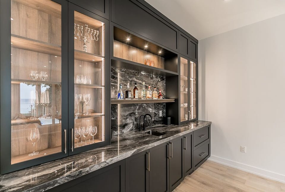 Our bar is complete with an ice maker, drinking water faucet, and a sink.