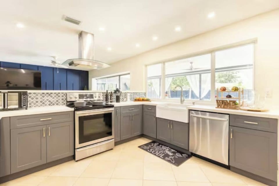 Open kitchen with coffee machine toaster microwave oven.