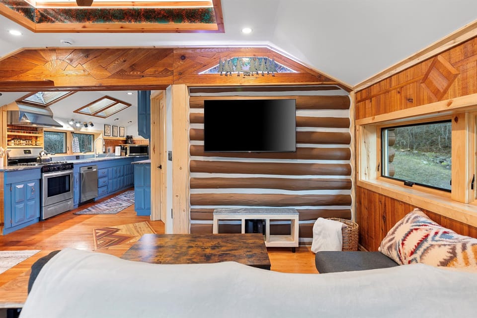 The main living space offers abundant natural light from the plentiful windows.