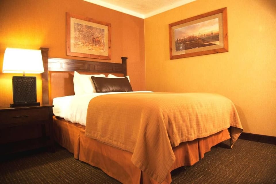 Relax in a king room with bright windows and workspace.