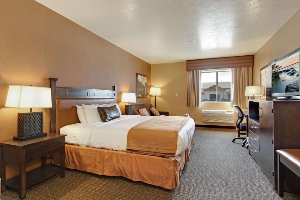 Drift off in a serene queen room beside sunny windows.