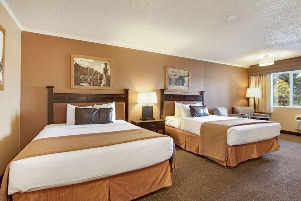 Unwind in a spacious double-queen room with cozy seating.