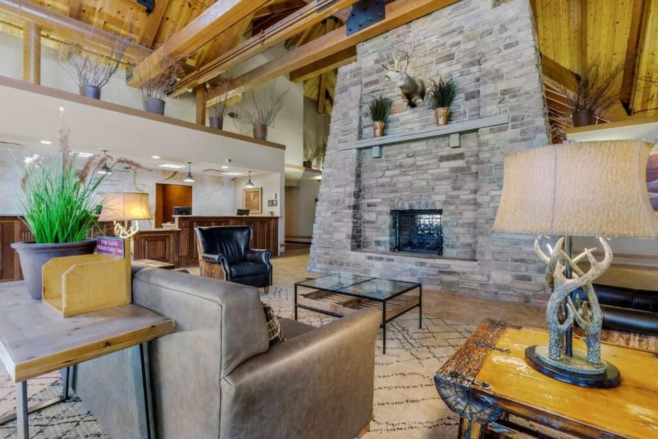 Relax fireside in a rustic lounge with cozy seating.