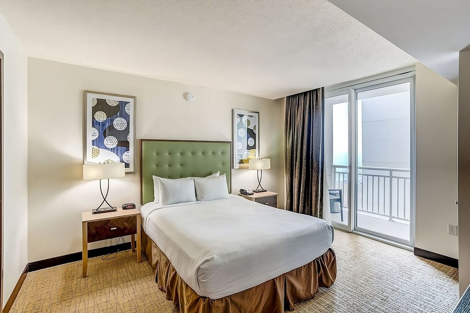 Drift into crisp linens beside balcony doors and fresh air.