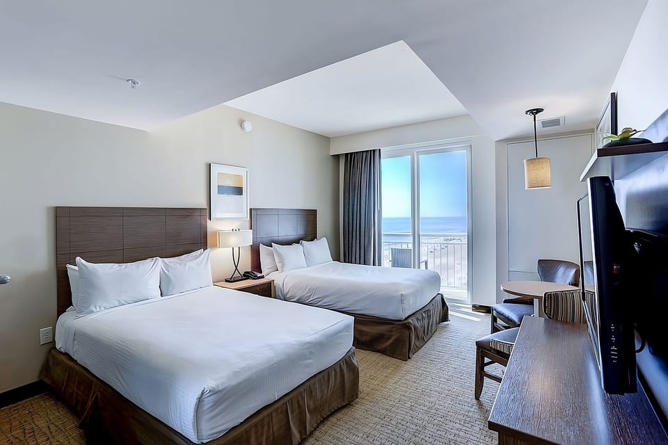 Unwind in crisp beds with soothing oceanfront balcony views.