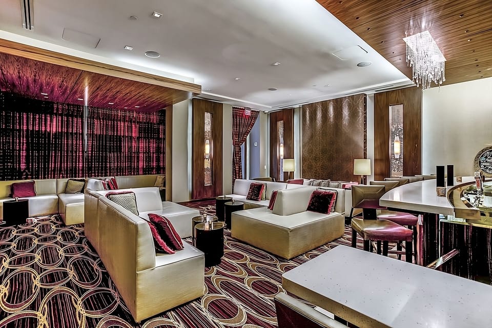Gather on chic sofas under warm lighting for late-night lounging.