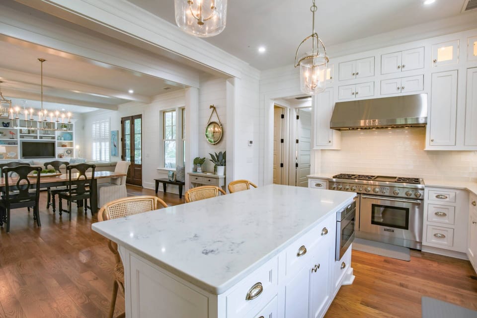 The home's lower primary suite is located through this doorway behind the kitchen.