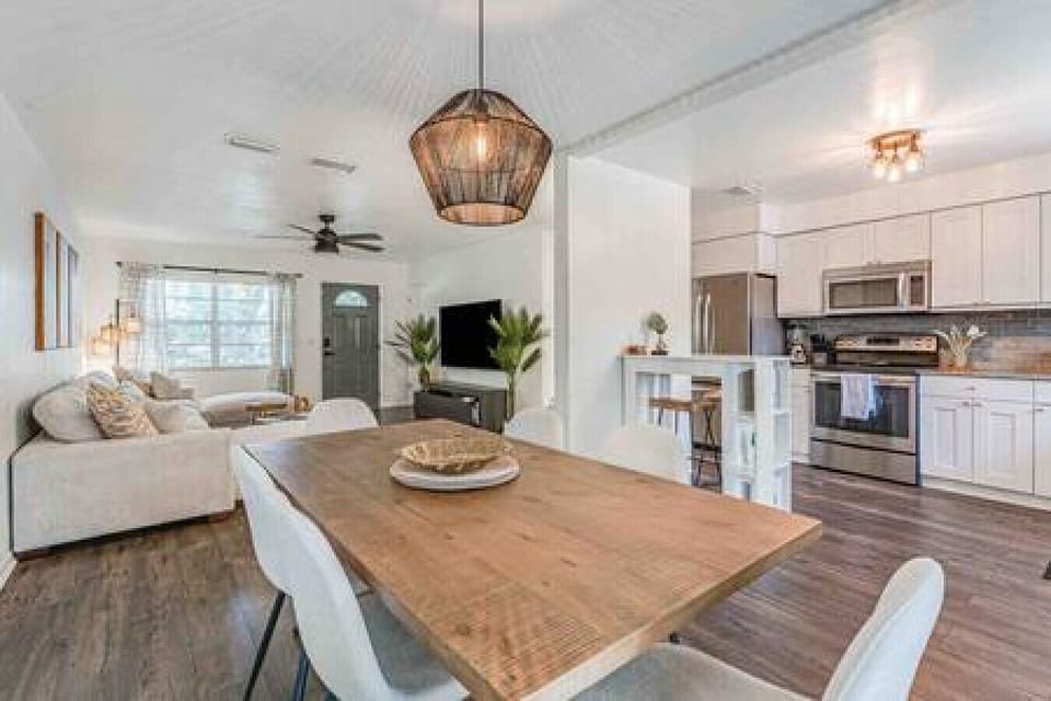 Beautiful Dining Room Table w/ Seating for Six Underneath Hanging Wicker Light Fixture