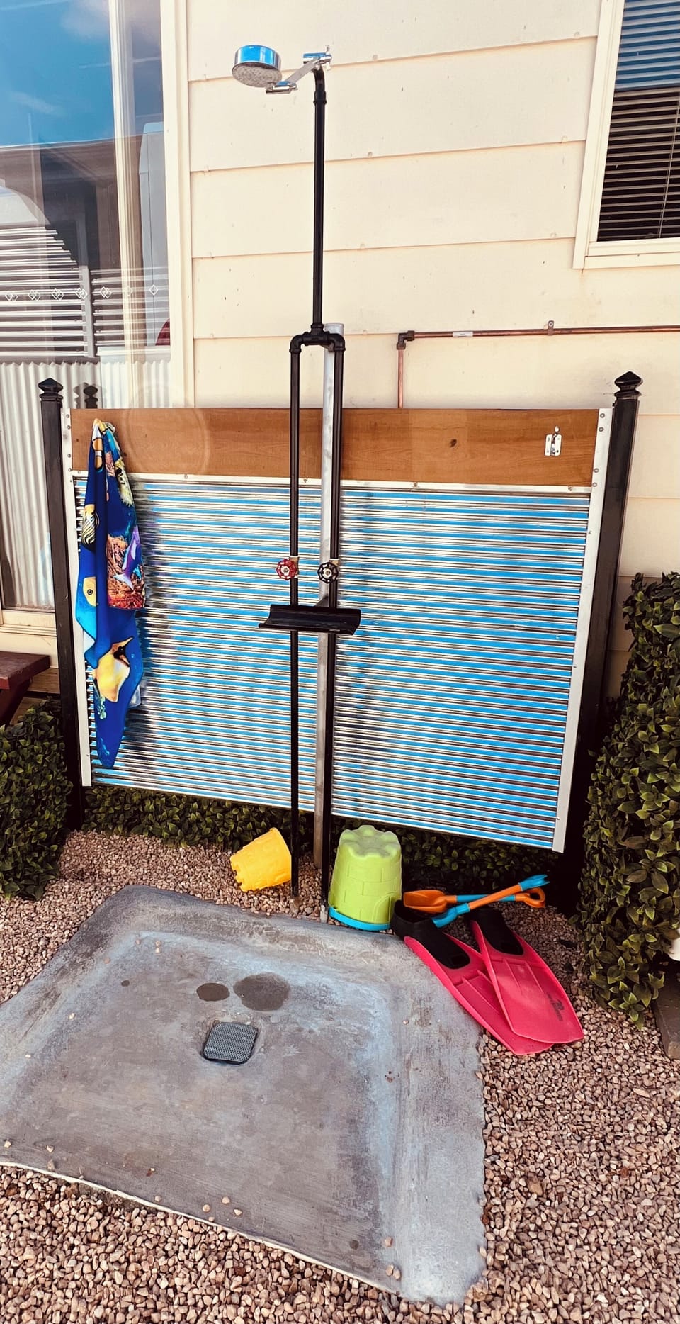 Outdoor shower has hot and cold water.
