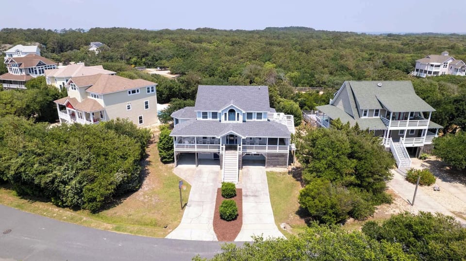 Drone - Double driveways for parking and a warm bright exterior to meet you and your guests.