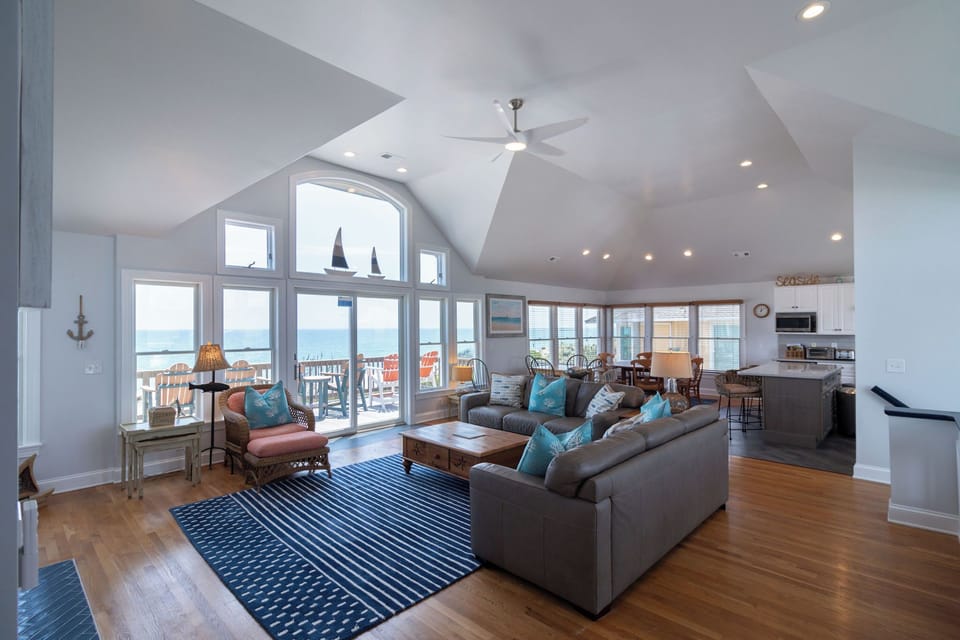 Living Room ocean view - Open concept living room with ocean views, tiled fireplace and ample seating.