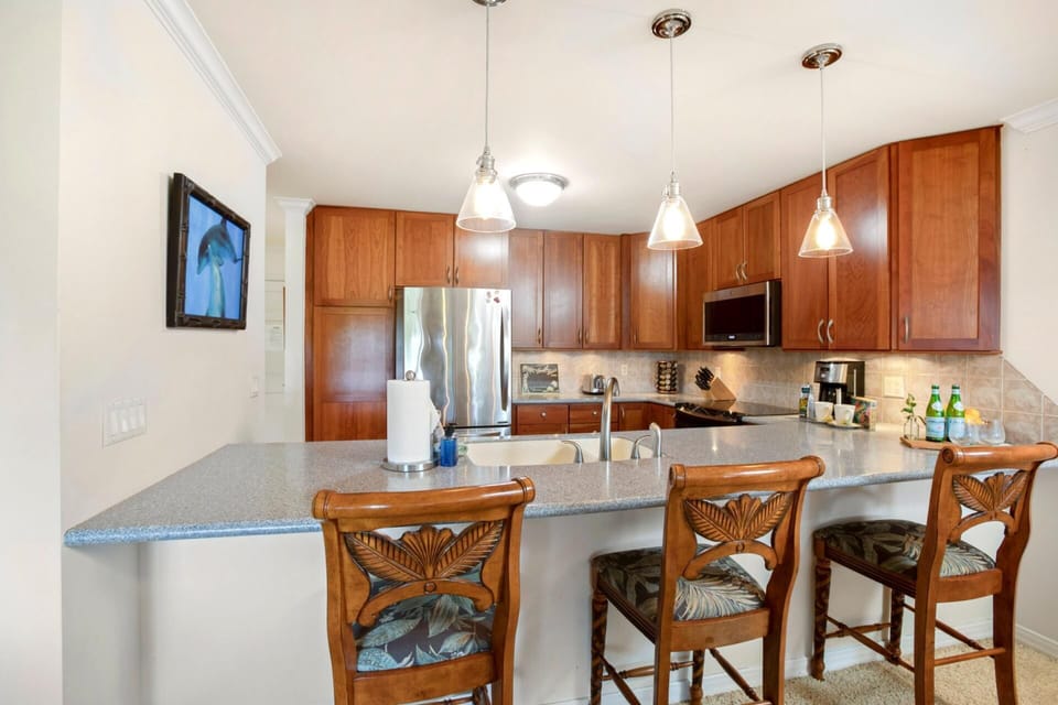 A fully equipped modern kitchen with stainless steel appliances, granite countertops, and all the essentials for a home-cooked meal.  