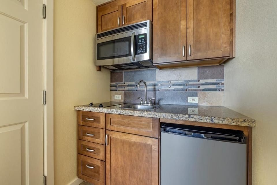 Enjoy easy meals with a sleek kitchenette and mini-fridge