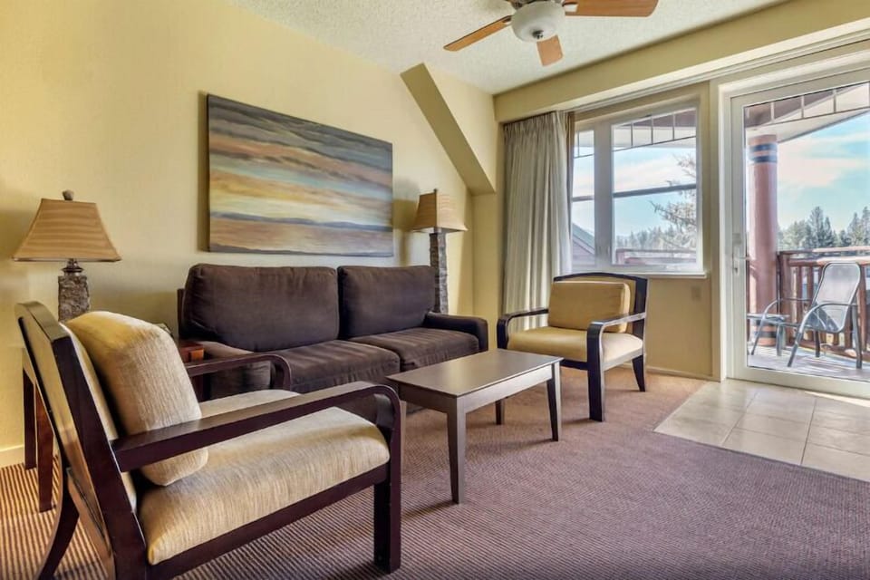 Lounge in sunlit comfort steps from the private balcony.