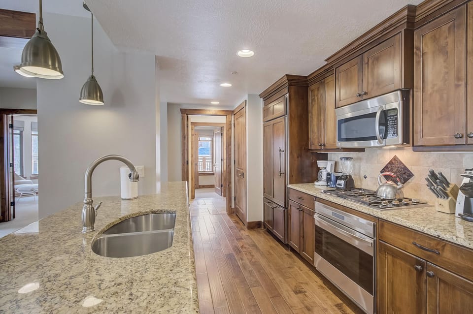 The kitchen is stocked with the tools you need to cook in and high end appliances.