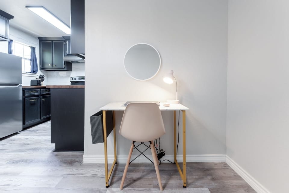 Boost your productivity in our well-equipped workspace, featuring a dedicated table and a convenient lamp for focused efficiency and creativity.