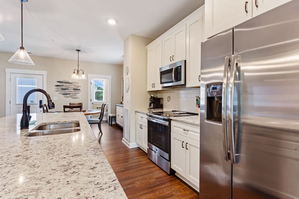The open-concept Kitchen with Stainless Steel Appliances is ideal for whipping up a delicious meal to enjoy together as a family.
