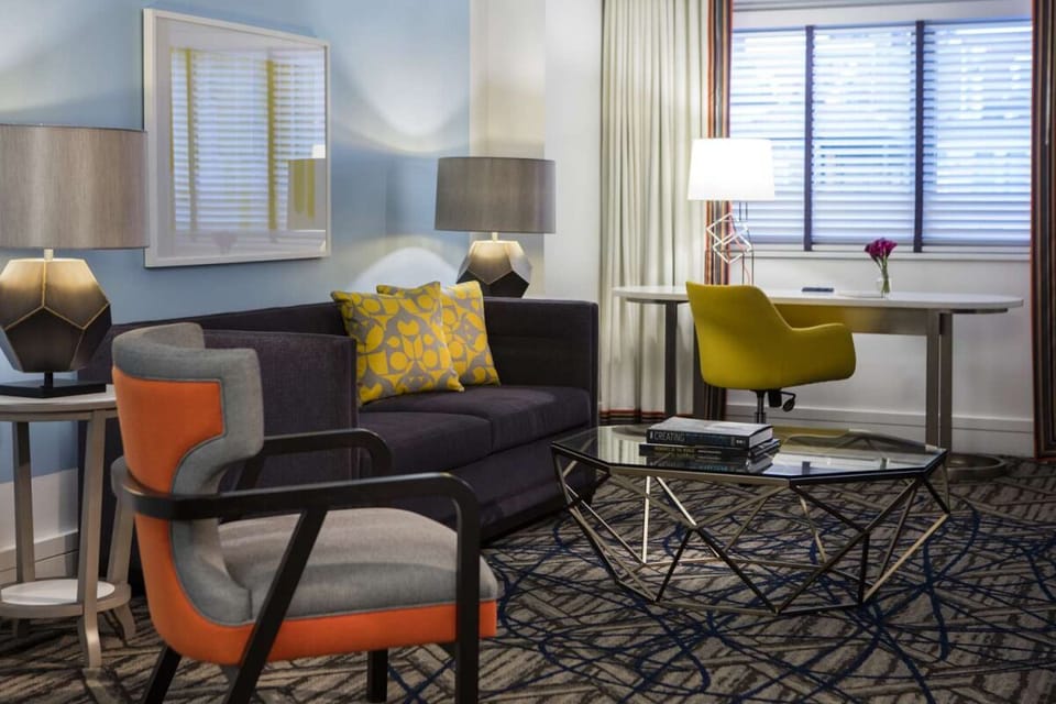 Sip coffee on the sofa beside a bright work desk.